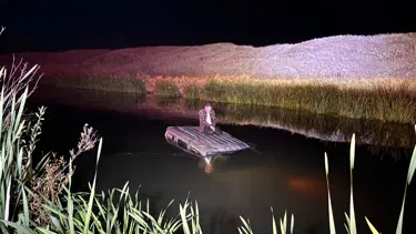 Nehre düşen aracının üstünde yardım bekledi