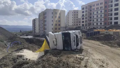 Antakya’da kum yüklü kamyon devrildi