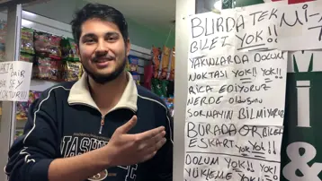 Eskart soruları çileden çıkardı, dükkan camına yazı astı. Şimdi herkes fotoğraf çektiriyor