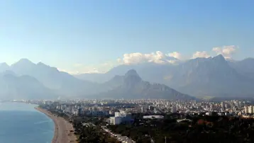 Aynı fotoğrafta hem yaz hem kış! Bir yanda kar yağışı, diğer yanda denize girenler