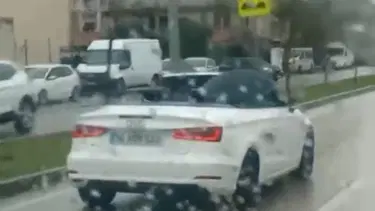 Milyonluk arabada ilginç anlar: Islanmamak için şemsiye açtı