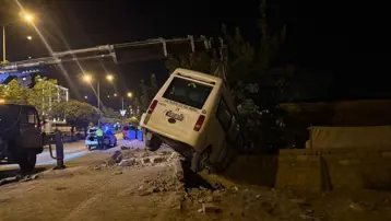 Minibüs bahçe duvarında asılı kaldı